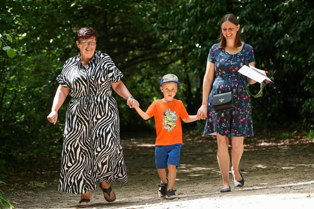 Angela Larkman, Thomas, 5, and his mother, Kay Larkman enjoy a stroll in the sun at Holly Hill Woodland Park