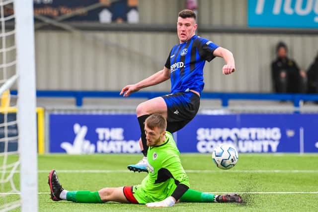 The Castle keeper tries to keep out a shot from Clanfield's Fred Penfold. Picture by Richard Murray