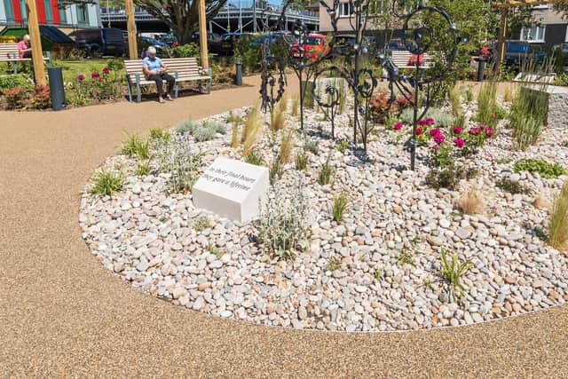 A visitor sits in the Garden of Life at QA Hospital. Picture: Mike Cooter (090621)