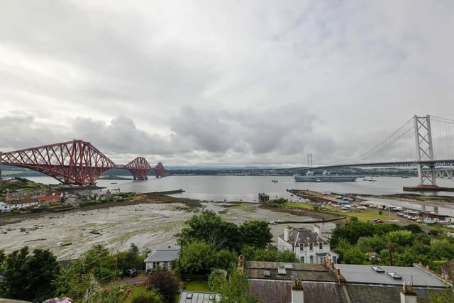 HMS Queen Elizabeth leaving Rosyth in Fife, Scotland, and sailing under the Forth bridge. She is due to return home to Portsmouth on July 30.