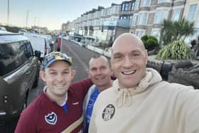 Tyson Fury poses for a selfie with Pompey fans Brendan Tuttiett and Richard Line before the Blues' game against Morecambe on Saturday