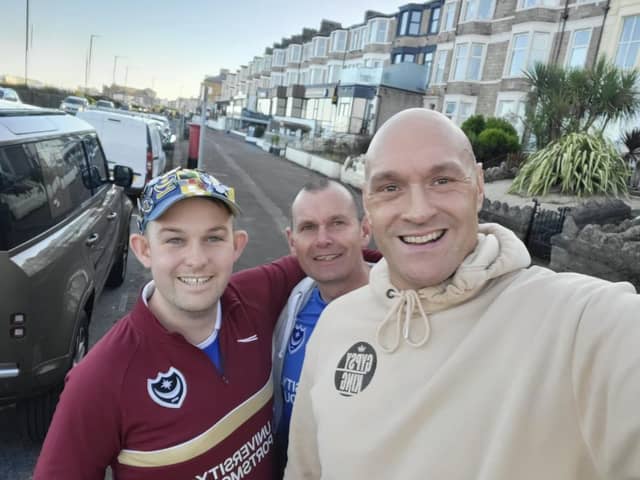 Tyson Fury poses for a selfie with Pompey fans Brendan Tuttiett and Richard Line before the Blues' game against Morecambe on Saturday