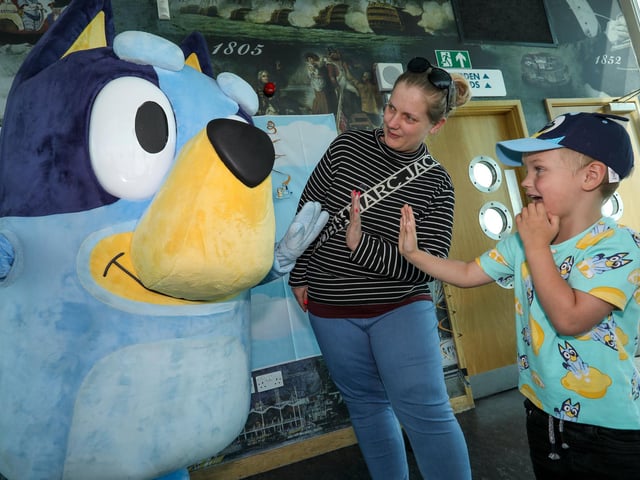 Lyndsey Williams and Jude, 4, give Bluey a high five.Picture: Chris Moorhouse (290524-33)