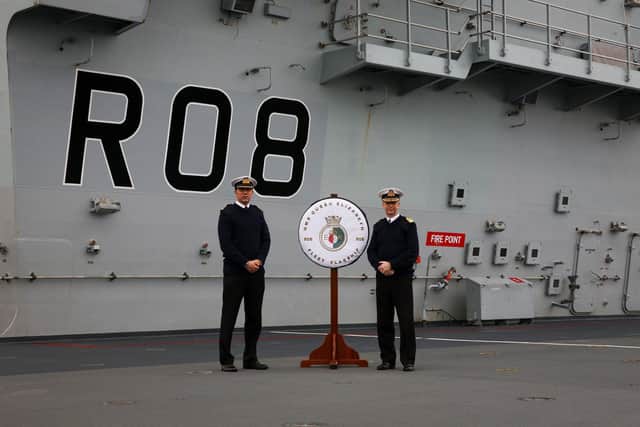 CO of HMS Queen Elizabeth, Captain Angus Essenhigh RN on the left with the  Fleet Commander, Vice Admiral Jerry Kyd on the flightdeck. 

HMS Queen Elizabeth today assumed the role of Fleet Flagship as the Royal Navy.