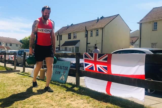 Dan Fallon tackling an epic marathon crawling and carrying a 45kg weight in his garden.