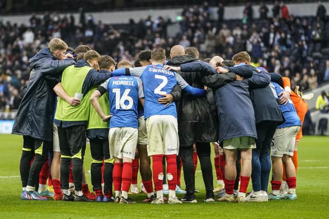 Pompey's playing squad and staff held an on-pitch huddle after the final whistle against Spurs. Picture: Jason Brown/ProSportsImages