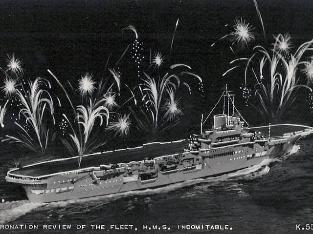 HMS Indomitable lit up for the coronation fleet review at Spithead in 1953. Picture: Avaon Davies