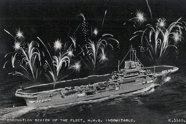 HMS Indomitable lit up for the coronation fleet review at Spithead in 1953. Picture: Avaon Davies