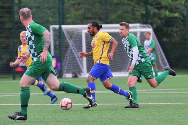 Jagjit Singh (yellow) on the attack for Meon Milton in the Billy Hill Cup final against Mob Albion. Picture: Martyn White.