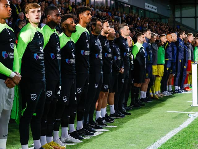 Pompey boss Danny Cowley, centre, along with his coaching staff and substitutes observe a minute's silence in respect of the late Queen ahead of tonight's game against Burton at the Pirelli Stadium    Picture: Simon Davies.