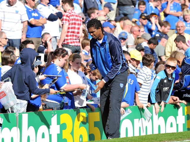 Kanu signing autographs for fans during half-time of Pompey's home game against Preston in 2011
