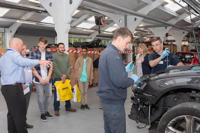 Some potential apprentices and families and sponsors are shown a cover being be prepared for repair in the workshop of the Apollo Motor Group.

Picture Credit: Keith Woodland