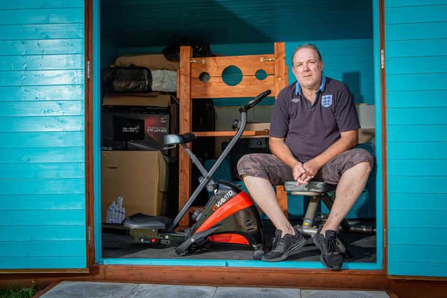 Darren Armistead in the garden shed where he works out