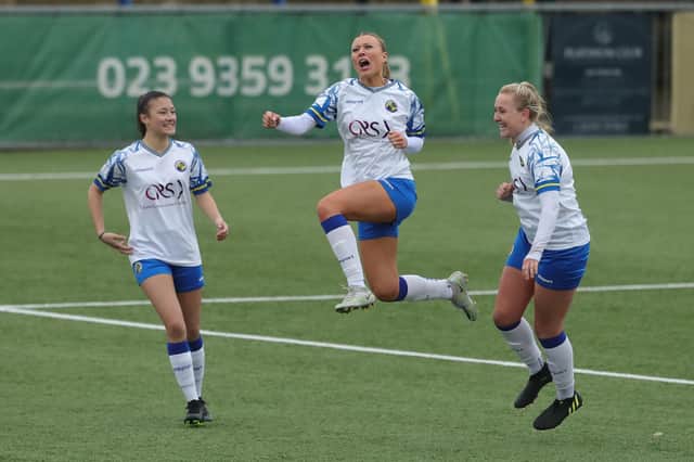 Sarah Butterworth (middle) celebrates one of her 50 goals for Hawks this season - Chyna Bennett (left) and  Jodie Burchell are also pictured. Picture by Dave Haines