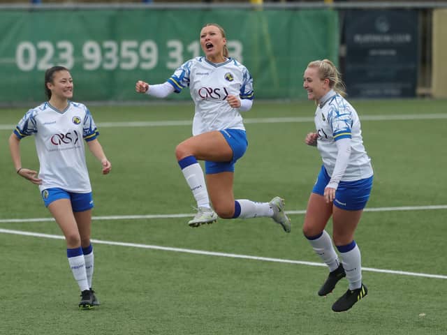 Sarah Butterworth (middle) celebrates one of her 50 goals for Hawks this season - Chyna Bennett (left) and  Jodie Burchell are also pictured. Picture by Dave Haines