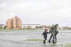 A family struggling against the wind in Southsea Common during Storm Henk. Picture: Habibur Rahman.