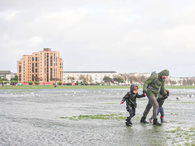 A family struggling against the wind in Southsea Common during Storm Henk. Picture: Habibur Rahman.