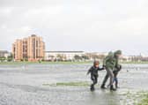 A family struggling against the wind in Southsea Common during Storm Henk. Picture: Habibur Rahman.