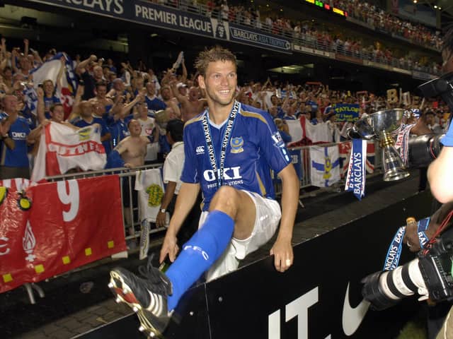 Hermann Hreidarsson jumps the fence to celebrate with the Pompey fans after the Blues' final victory against Liverpool on penalties.