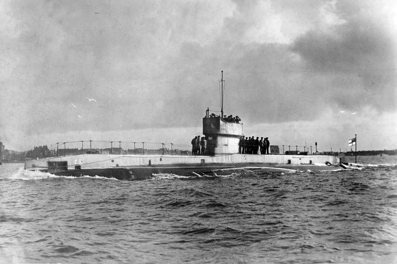 Officers and crew stand on deck around the conning tower of the Royal Navy E-class submarine HMS E3 while on patrol entering Fort Blockhouse submarine base near Gosport circa 1914 off Gosport, United Kingdom. HMS E3 was sunk in the first ever successful attack on one submarine by another, when she was torpedoed on 18 October 1914 by U-27. (Photo by Paul Thompson/FPG/Getty Images)