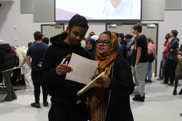 Student Fahmi receiving his results