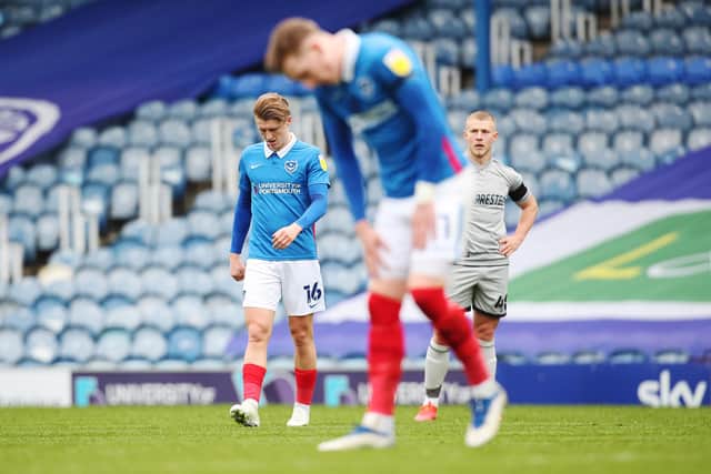 Ronan Curtis and George Byers are dejected following the 2-1 defeat to Burton at Fratton Park. Picture: Joe Pepler