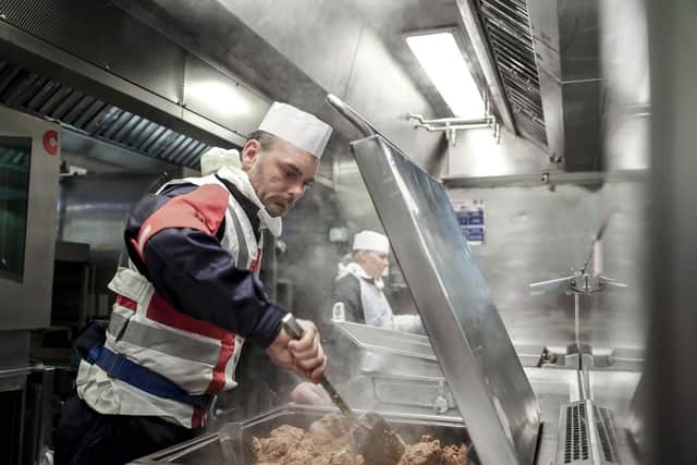 Chefs in the galley preparing action messing at action stations during HMS Defender's latest training at sea.