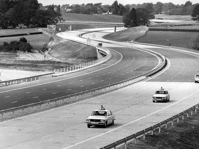 A couple police cars drive up the empty M27 in September 1975. The News PP4966