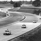 A couple police cars drive up the empty M27 in September 1975. The News PP4966