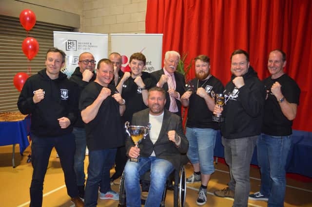 Knox White with the trophy and Heart of Hayling Boxing Club members after they had won the Club of the Year award in the annual Havant Borough Council Sports Awards.