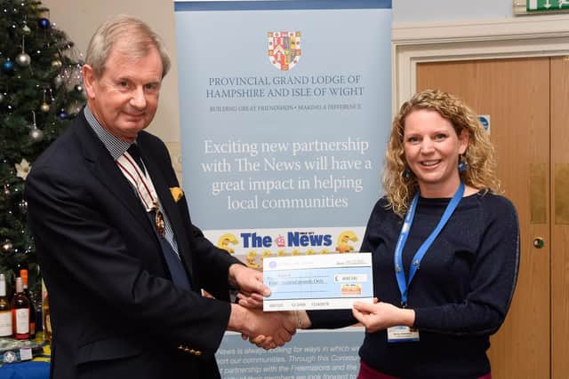 Pictured is: Deputy Lord Lieutenant of Hampshire Charles Ackroyd presents a cheque to Motiv8 and Becky Stotesbury.
Picture: Keith Woodland (041221-26)