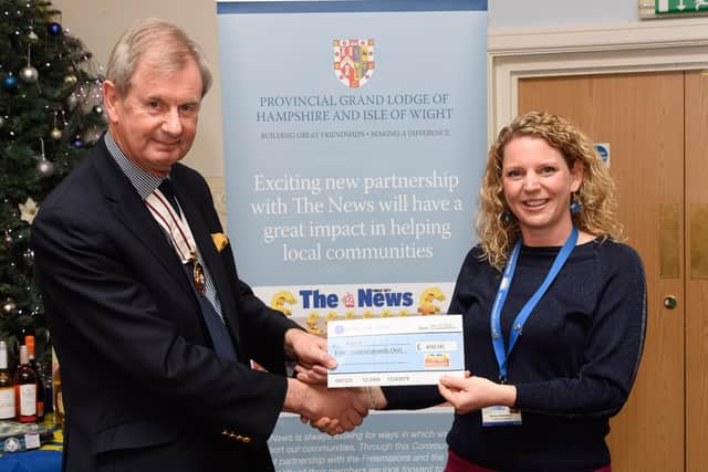 Pictured is: Deputy Lord Lieutenant of Hampshire Charles Ackroyd presents a cheque to Motiv8 and Becky Stotesbury.


Picture: Keith Woodland (041221-26)