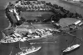 HMS Excellent on Whale Island aerial view 1970. Bottom right at her mooring is the Royal Yacht Britannia where she was always located when not in use. The grey ship to the left is HMS Rame Head that was a Canadian ship. She was a training ship later followed by HMS Bristol which still uses the birth to this day. Just above the playing field are the barrack blocks.