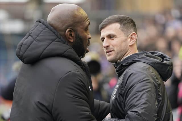 Pompey boss John Mousinho shakes hands with his Sheffield Wednesday counterpart Darren Moore