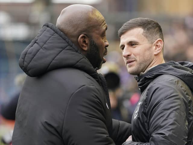 Pompey boss John Mousinho shakes hands with his Sheffield Wednesday counterpart Darren Moore