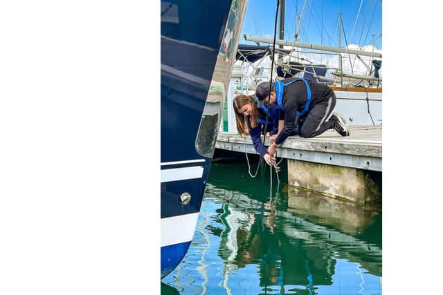 Dr Ian Hendy and Stephanie Northen putting the biohut cage into Haslar Marina.