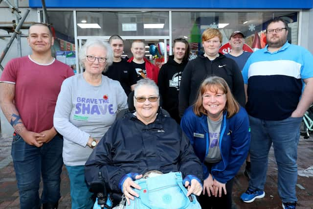 Standing left to right, Connor Lewis, Anne Stigar, Robert Hicks, Marcus Thomas, Sam Thomas, Brendan Thomas, David Ashby, front, Pauline Nolan and Jeanette Thomas. Jeanette Thomas and family and friends have their heads shaved for Macmillan in Gosport High Street
Picture: Chris Moorhouse (jpns 121122-43)