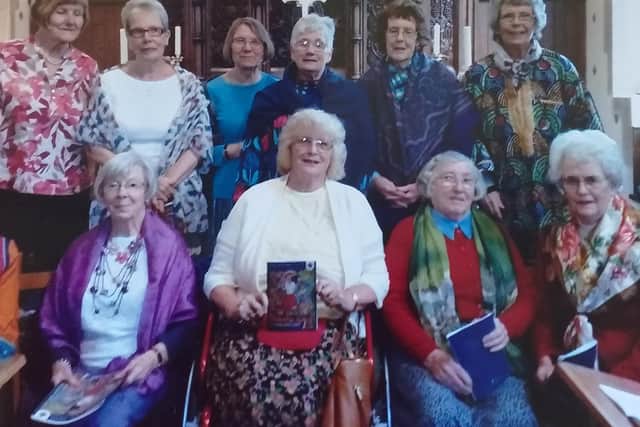 Members of the committee (Elizabeth White is top right) at the service last March