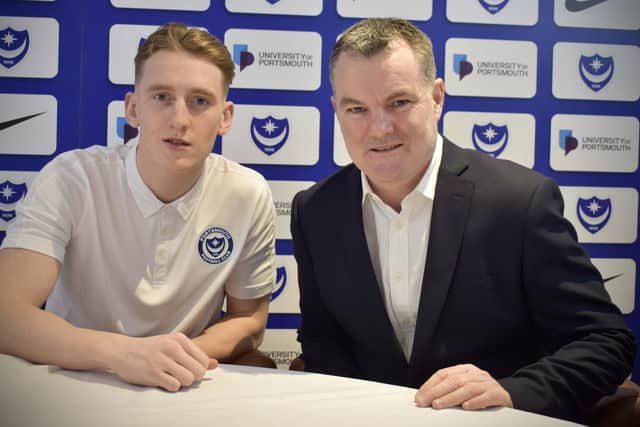 Ronan Curtis signs his new Pompey contract with chief operating officer Tony Brown. Picture: Portsmouth FC