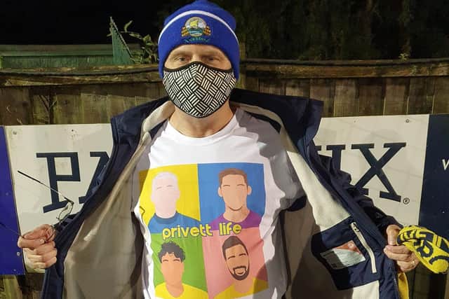 Phil Churcher showing off his Privett Life t-shirt at a Gosport game.