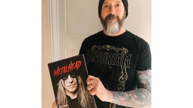Highbury College tutor Darren Salder holding the first edition of Metalhead Magazine.