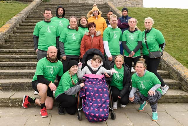 Pictured is: Lana with those fundraising for her.
Picture: Keith Woodland (060321-9)