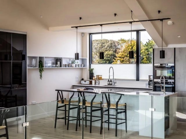 The listing says: "This outstanding, contemporary house has been designed to take full advantage of its wonderful outlook accross the picturesque beach huts and the greensward to the sea."