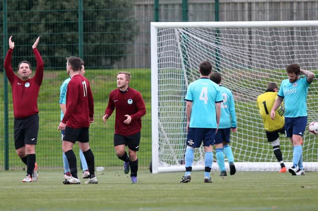 Harvey Herringshaw, third left, celebrates a goal for Burrfields (maroon) against Portchester Rovers last December. Pic: Chris Moorhouse