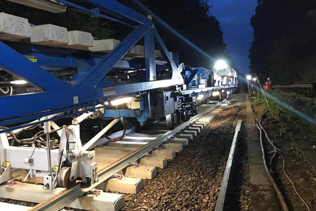 A new track construction train laid down sleepers at a rate of up to 10 per minute.