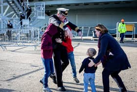 Commanding Officer Captain Richard Hewitt OBE greets his wife Clara his children Oliver, 10, William, eight and Ben two.