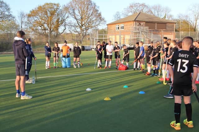 Fareham's junior section players take on information from England aces Lily Owlsey and Ollie Willars