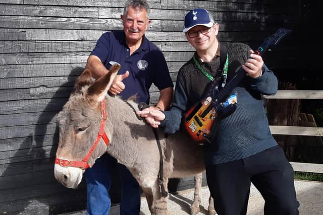 Rusty the donkey with volunteer Phill Upshall (left) and Martin Nash fom Lily's Bar (right)