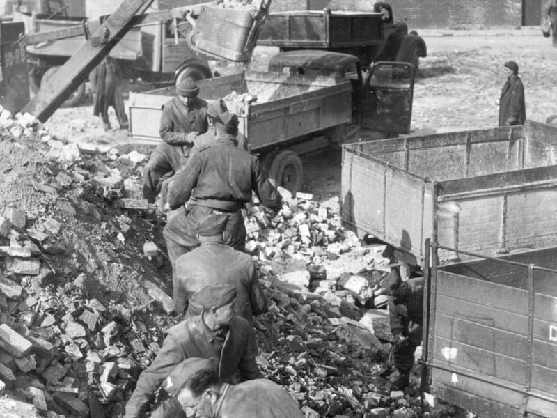 Soldiers working at the St. Paul's Square Hardcore Dump, where rubble from bombed houses was gathered so it could be used for various purposes, including as the foundations of the embarkation 'hards' (concrete blocks on the beaches, to avoid them being churned up by vehicles) used by troops embarking onto landing craft for D-Day.