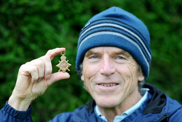 Mark Williams, 71, with the WW1 medal he discovered in his back garden.

Picture: Sarah Standing (231020-8127)